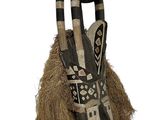 an image of a wooden mask with horns and feathers on a white background