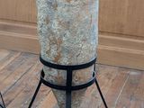 a large vase that is on a stand on the floor