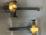 pair of brass wall sconces on a gray background