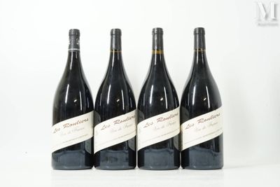 four bottles of wine are lined up on a white surface