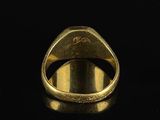 an image of a gold ring with a diamond set in the center