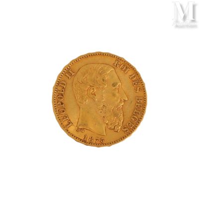 a close up of a gold coin on a white surface