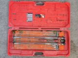 a red tool case with tools in it on the ground
