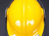 a yellow hard hat on a black background