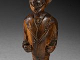 an image of a wooden statue of a man wearing a top hat