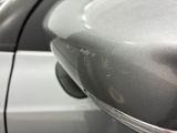 a close up of a car ' s side mirror and door handle