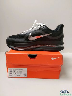 a pair of black and white shoes on top of an orange box