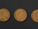 three gold sovereigns, one of which is a sovereign and one of which is a sovereign
