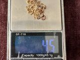 a gold chain on top of a scale on a red cloth