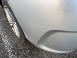 a close up of a car ' s front bumper with a cat on it