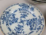 a lot of blue and white plates and bowls on the table