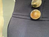 a close up of a dress shirt and pants with buttons on it