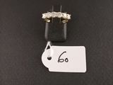 a diamond ring with a price tag on a black surface