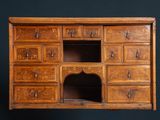 an old wooden dresser with many drawers and drawers on it