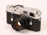 a black and silver camera on a white background