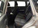 the back seats of a silver car with a black seat belt