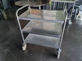 a metal cart that is sitting in the middle of a room