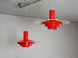two red lights hanging from the ceiling in a room