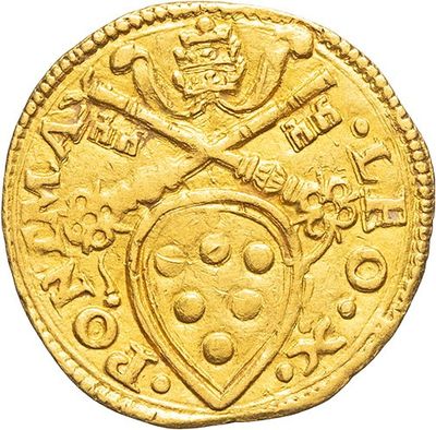 a close up of a gold coin with a shield on it