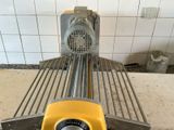 a yellow machine that is sitting on the floor