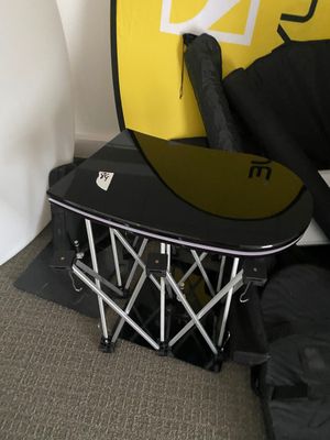 a snowboard sitting on top of a table next to a surfboard