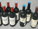several bottles of wine are lined up in a row on a table