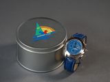 a small tin with a watch on it next to a small tin with a watch inside