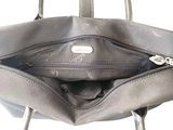grey leather purse with zippers open on a white background