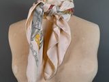 a close up of a mannequin wearing a scarf on a mannequin