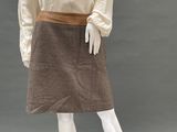 an image of a mannequin wearing a white shirt and brown skirt