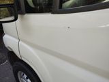 a white van that is parked on the side of the road