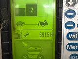 an image of a green and black machine with buttons on it