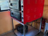 un four rouge posé sur un chariot en métal dans une cuisine