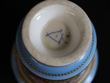a blue and white vase with a blue triangle on it