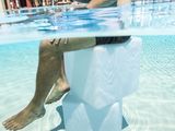 a man that is sitting on a toilet in the water