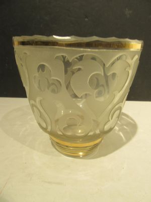 a glass bowl sitting on a table with a black background