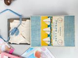 a box with a book and a pair of shoes on a table