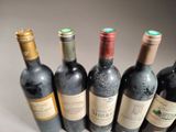several bottles of wine are lined up in a row