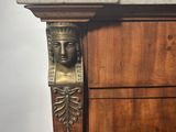 a marble head on the top of a wooden cabinet