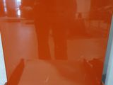someone is taking a picture of a red chair in a room