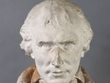 a statue of a man that is wearing a jacket
