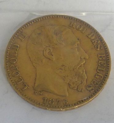 an old gold coin with a man ' s face on it