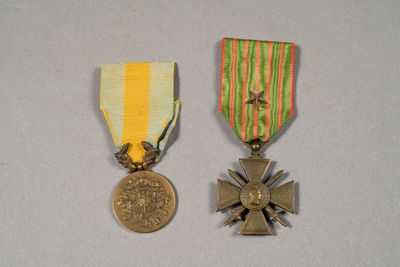 two medals and a medal on a table with a white background