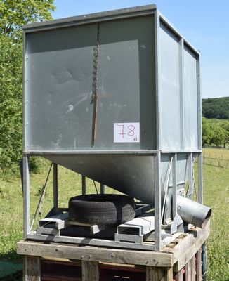 a large metal container with a tire on top of it