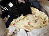 a pile of clothes that is sitting on a couch