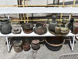 many pots and pans sitting on a white bench