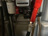 a gas pump with a red hose attached to it