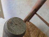 a baseball bat sitting on top of a wooden chair