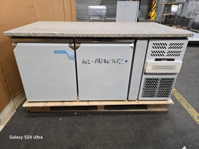 three refrigerators sitting on a pallet in a warehouse