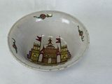 a small bowl with a picture of a castle on it